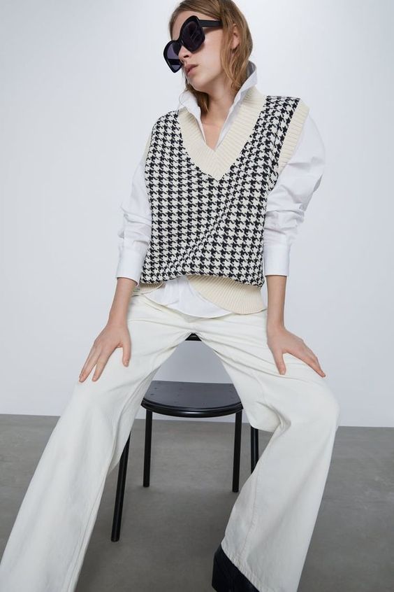 a white shirt with puff sleeves, a creamy printed knit vest, creamy pants for a trendy work look