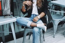 a white tee, blue jeans, a black blazer, silver ankle booties and a printed tote