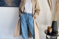 a white tee, blue slouchy jeans, tan heeled mules, a tan trench for a comfy and chic fall outfit