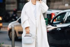 a white tee, high waisted pants, shoes, a wam coat and a small bag for this fall