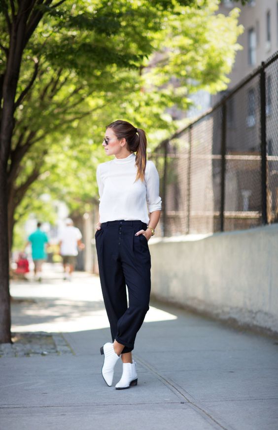 a white turtleneck, navy high waisted pants, white Chelsea boots for a contrasting look