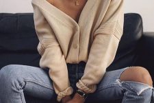 blue ripped jeans, a creamy cardigan tucked in, layered necklaces for a sexy look