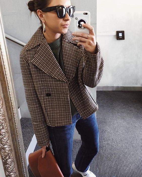a fall look with a grey top, blue jeans, white sneakers, a plaid cropped coat and a brown bag