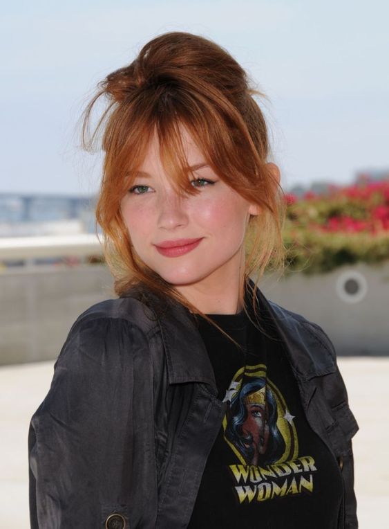 red hair in a top knot, with some bangs and a long and messy fringe is amazing