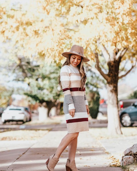 With beige hat and beige suede ankle boots