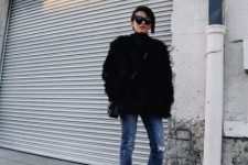 With black faux fur coat, black bag and black ankle boots