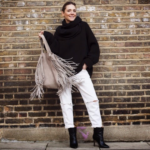 With black loose turtleneck, white loose distressed pants and black ankle boots