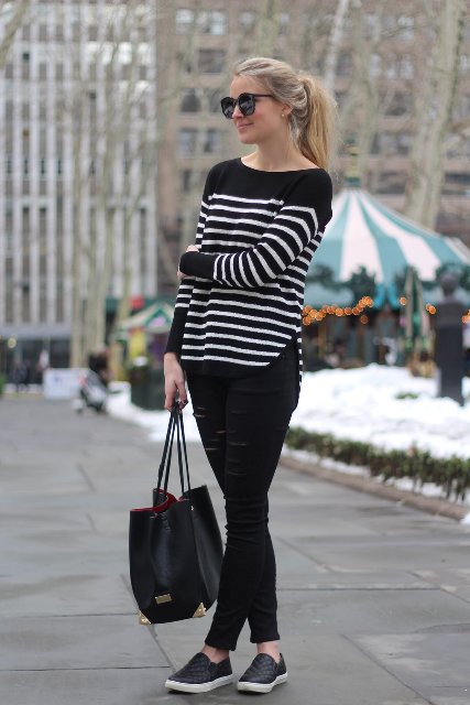 With black trousers, black leather flat shoes and tote bag