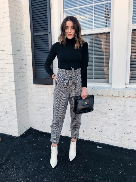 With black turtleneck, black leather clutch and white ankle boots
