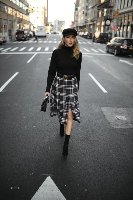 With black turtleneck, checked midi skirt, black bag and boots