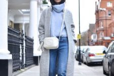 With gray coat, white bag, jeans and black boots