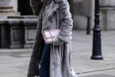 With gray fur coat, distressed jeans, pale pink bag and sneakers