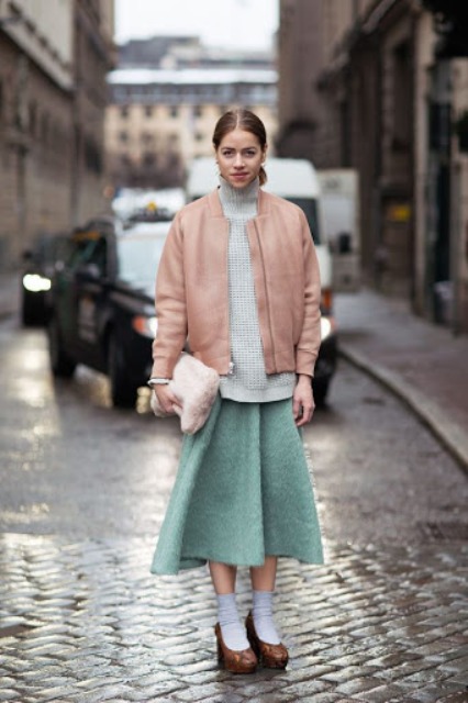 With gray turtleneck, fur clutch, mint green skirt and brown shoes