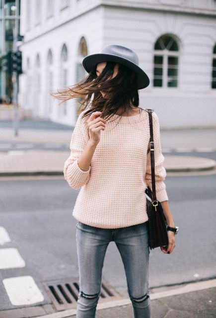 With hat, gray jeans and black bag