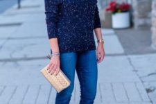 With navy blue jeans, beige clutch and black pumps