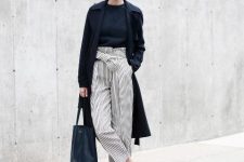 With navy blue shirt, black midi coat, two colored shoes and navy blue leather tote bag
