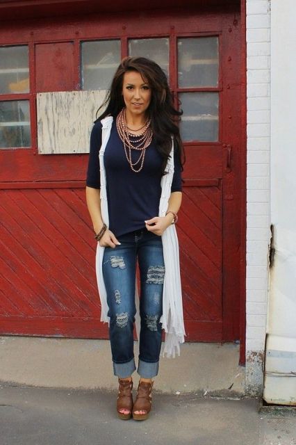 With navy blue shirt, white long vest and brown platform sandals