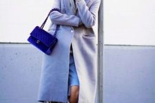 With pastel colored midi coat, navy blue velvet bag and sneakers