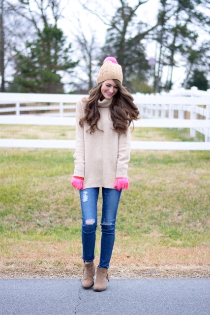 With pastel colored sweater, distressed jeans and suede boots