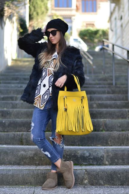 With printed cardigan, faux fur jacket, hat, distressed jeans and gray boots