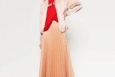 With red labeled t-shirt, peach colored pleated midi skirt and sneakers