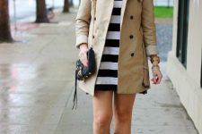 With white and black striped mini dress, beige trench coat and chain strap bag