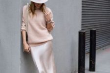 With white hat, bag, satin midi skirt and black shoes