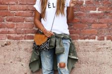 With white labeled t-shirt, olive green jacket, printed bag and embellished shoes