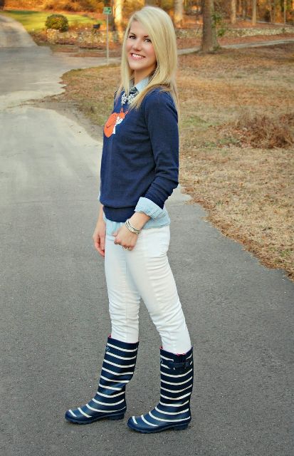 With white pants, light blue shirt and navy blue sweater