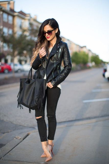 With white top, black leather jacket, distressed pants and beige high heels