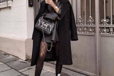 a black leather shirtdress, black tights, white combat boots, a black coat and a bag