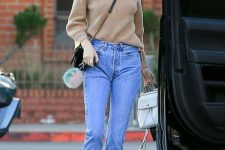a camel turtleneck, blue cropped jeans, black lace up booties and a black bag
