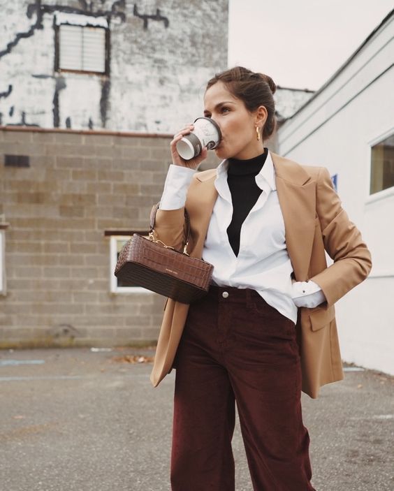 a casual work look with a black turtleneck, a white shirt, a tan blazer, burgundy pants and a brown bag