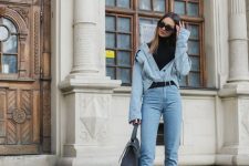 a chambray shirt, a black turtleneck, blue cropped jeans, black booties and a grey bag