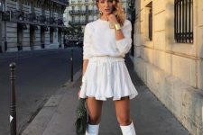 a chic outfit with a white fuzzy top, a white pleated mini, white boots, a tan beret and gold accessories