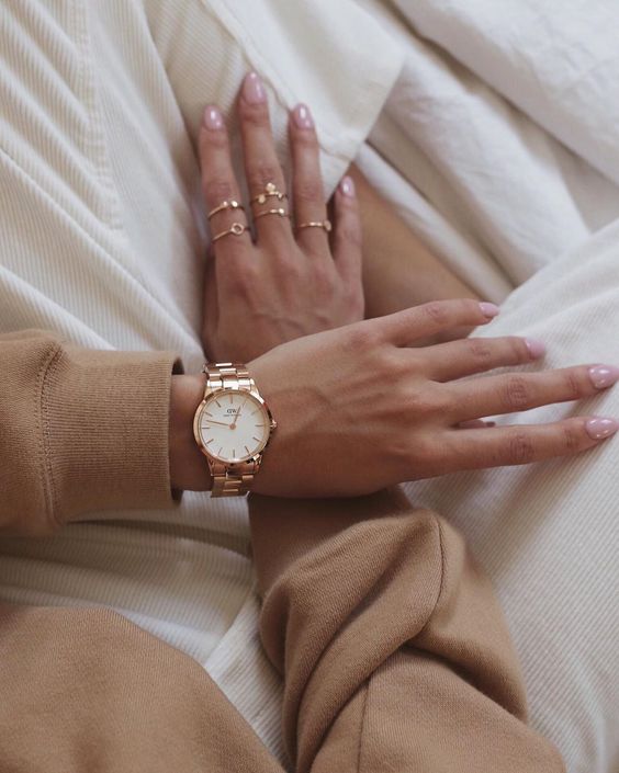 a copper bracelet watch and stacked copper rings create a soft and chic glow in your look
