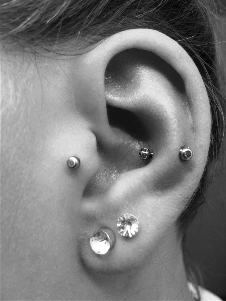 a double lobe piercing, a tragus piercing and a snug one for a bold and unusual look