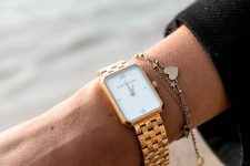 a gold bracelet watch plus a copper chain one with pendants for a relaxed and casual feel