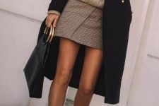 a grey chunky sweater, a plaid mini skirt, white booties, a black midi coat and a tote