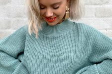 a light green cropped balloon sleeve sweater plus white jeans and statement earrings for the fall
