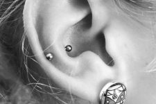 a lobe and a snug piercing with a statement earring look bold and very edgy