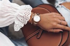 a mixed metal watch and a copper bracelet stacked plus rings finish off a soft girlish look