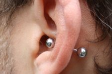 a simple male conch piercing done with a labret is a bold idea to stand out a lot