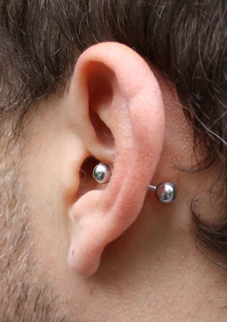 a simple male conch piercing done with a labret is a bold idea to stand out a lot