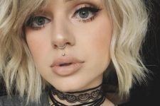 a stud medusa piercing paired with a ring in the septum for a bold and edgy look
