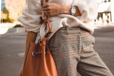 a white oversized chunky knit sweater, plaid pants, an amber bag are a comfy work outfit