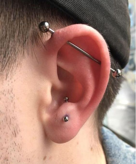 an anti tragus piercing plus an industrial one done with titan jewelry to match
