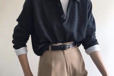 an office look with a white turtleneck, an oversized black shirt, tan pants and a black leather belt