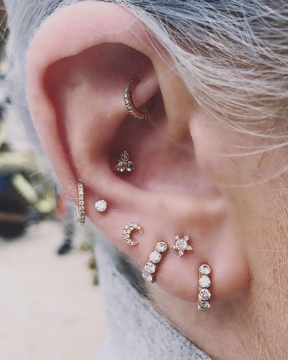 chic gold and diamond studs and hoops in the conch and rook, helix and lobe
