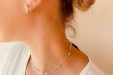 elegant ear piercings – a gold hoop in the forward helix and in the lobe